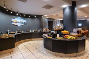 a hotel lobby with a counter with food on it at DoubleTree by Hilton Washington DC – Crystal City in Arlington