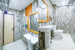a bathroom with a sink and a toilet at Ayaan Residency in Noida +54 photos