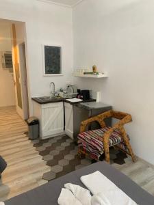 a kitchen with a counter and a sink in a room at Manello Home Art in Athens