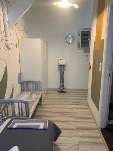 a hallway of a room with a refrigerator and a table at Manello Home Art in Athens