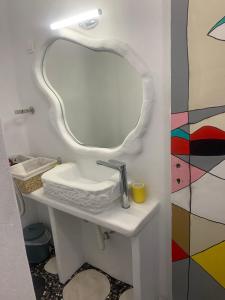 a bathroom with a sink and a mirror at Manello Home Art in Athens