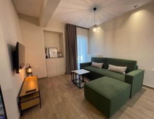 a living room with a couch and a table at Cashmere axd in Alexandroupoli