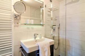 a white bathroom with a sink and a shower at Fewo Wegen in Salem +25 photos