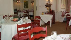 a dining room with tables and chairs with wine glasses at Hotel Keller in Kreuztal