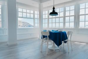 a dining room with a blue table and chairs at The Sea Corner Vacacional La Palma in Santa Cruz de la Palma
