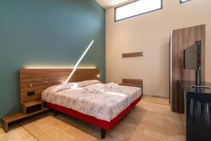 a bedroom with a bed and a television in it at Le Stanze di Gianmarmo - Galleria 41037 in Mirandola