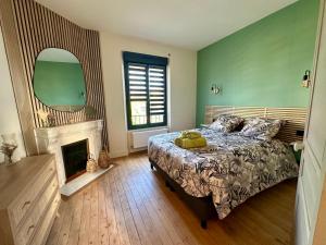 a bedroom with a bed with a teddy bear on it at Gîte La Villa Marcelle in Mareuil-le-Port
