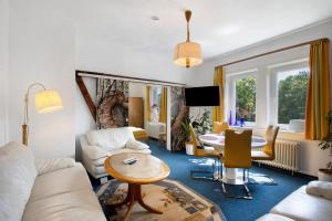 a living room with a couch and a table at Der Falkenhorst in Bad Sachsa