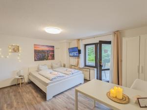 a living room with a couch and a table at B2 - Urlaubsmagie - mit Terrasse& Grill direkt am Wanderweg in Sebnitz