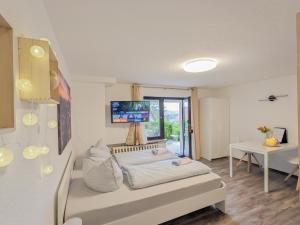 a living room with a couch with a tv on the wall at B2 - Urlaubsmagie - mit Terrasse& Grill direkt am Wanderweg in Sebnitz