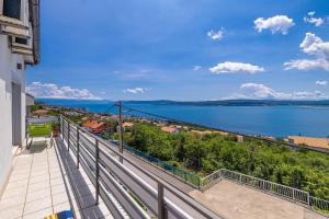 a balcony with a view of a body of water at Hot Tub, Pool & Stunning View #Guest House Stella# in Dramalj