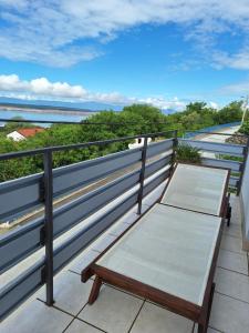 a bench on a balcony with a view of the water at Hot Tub, Pool & Stunning View #Guest House Stella# in Dramalj +64 photos