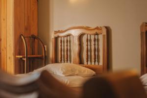 a bedroom with a bed with a wooden headboard at Gites La Boletiere in Saint-Étienne-du-Valdonnez +21 photos