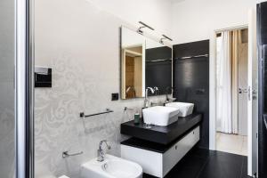 a bathroom with two sinks and a toilet at Villa Badessa in Noto +57 photos
