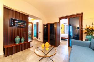 a living room with a couch and a table at Punta Chiarito Resort in Ischia