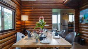 a dining room with a wooden table and chairs at Yukui Stay in Terabaru