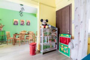 a room with a table and a stuffed animal on a shelf at Bohemian City Home near Centre in Thérissos