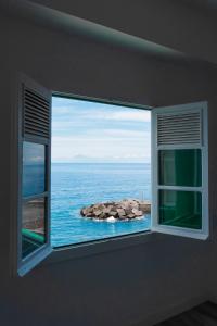 a window in a room with a view of the ocean at The Sea Corner Vacacional La Palma in Santa Cruz de la Palma