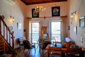 a living room with a table and chairs at Amorosa House in Symi