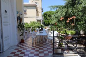 a patio with a table and chairs on a checkered floor at B&B Villa Pallante in Bari