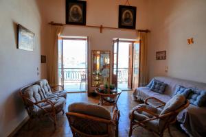 a living room with a couch and chairs at Amorosa House in Symi +33 photos