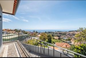 a balcony with a view of the ocean at Villa Pedreiro in Funchal