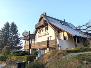 a building with a clock on the side of it at B2 - Urlaubsmagie - mit Terrasse& Grill direkt am Wanderweg in Sebnitz +19 photos