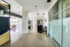 an empty hallway of an office building with glass walls at RedLiving Apartemen Enviro Cikarang - Stars Rooms in Cibeber