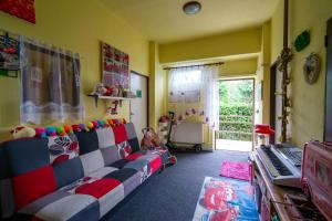 a childs room with a couch and a keyboard at Penzion Tomy1 in Horní Planá
