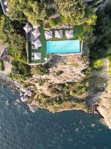 an overhead view of a pool next to a body of water at Hotel Piccolo Sant'Andrea in Praiano