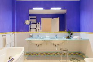 a bathroom with two sinks and a mirror at Hotel Piccolo Sant'Andrea in Praiano