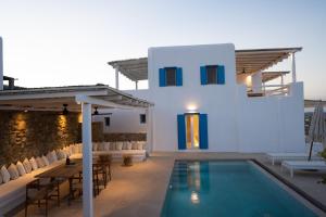 a villa with a swimming pool and a house at Sunrise Villa - Sea View Private Pools in Mikonos