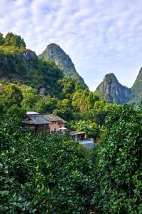 a view of a valley with mountains in the background at Yangshuo Yunshe Mountain Guesthouse in Yangshuo