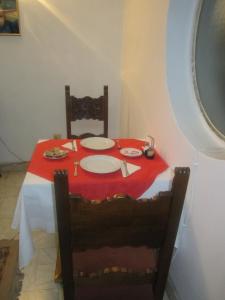 a table with a red table cloth on it with a red table cloth at Pensiunea Helvetia in Bucharest