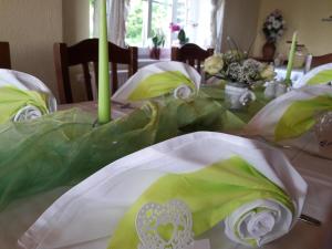 a table with green and white items on it at Gasthaus Talsperre -Gaststätte und Pension- in Eibenstock