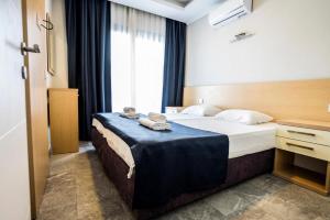 Postel nebo postele na pokoji v ubytování M2 Hotel