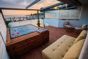 a hot tub on the roof of a building at Da Luz Boutique Hotel in Sarandë