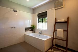 a bathroom with a bath tub and a window at Goatfell - Nuwara Eliya in Kandapola +52 photos