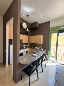 a kitchen with a table and chairs in a room at URBAN Center Apartments in Tarragona +156 photos