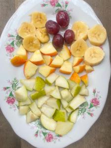 a plate filled with fruit on a table at Posada mama nati, arusí in Nuquí