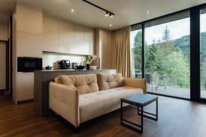 a living room with a couch and a kitchen at PROSTIR in Korostov