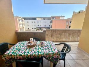 a table with a blanket on top of a balcony at Dimora del Sole in Brindisi