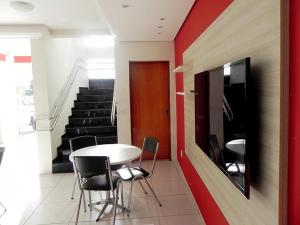 a room with a table and chairs and stairs at Hotel Village Premiun in Bebedouro