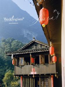 a building with red lanterns on top of it at Yangshuo Yunshe Mountain Guesthouse in Yangshuo