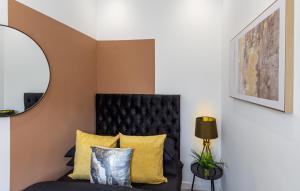a living room with a black couch and a mirror at The Lanes Deluxe - Rose Platinum Properties in Brighton & Hove