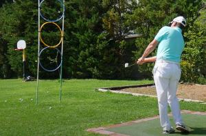 a man playing a game of golf in a park at GGA Albatross Villa in Afantou