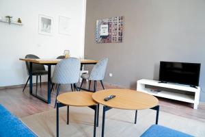 a living room with a table and chairs and a tv at Ruhige Wohnung nähe U Bahn Free Parking in Vienna +14 photos
