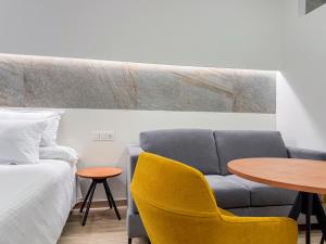 a living room with a couch and a table at Torreluz SUITES in Almería +28 photos