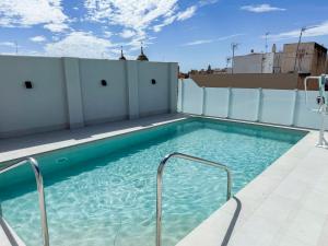 a swimming pool on the roof of a building at Torreluz SUITES in Almería