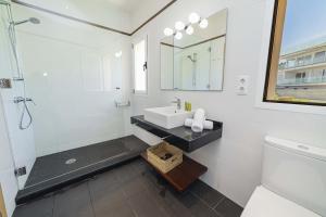 a white bathroom with a sink and a mirror at Villa Garau / Heura 8 in Alcudia +46 photos